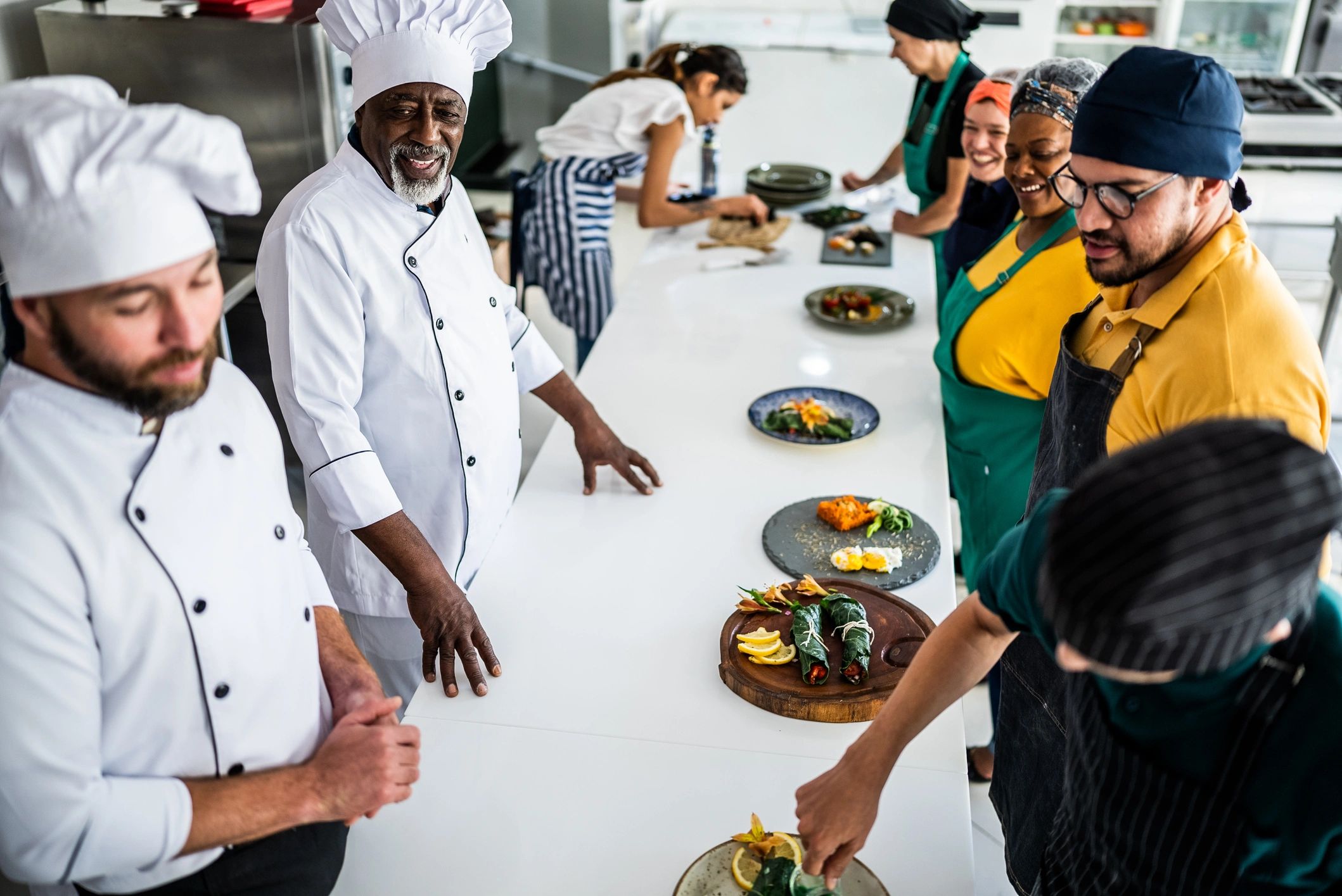 Chef analyzing food prepared by students during cooking class