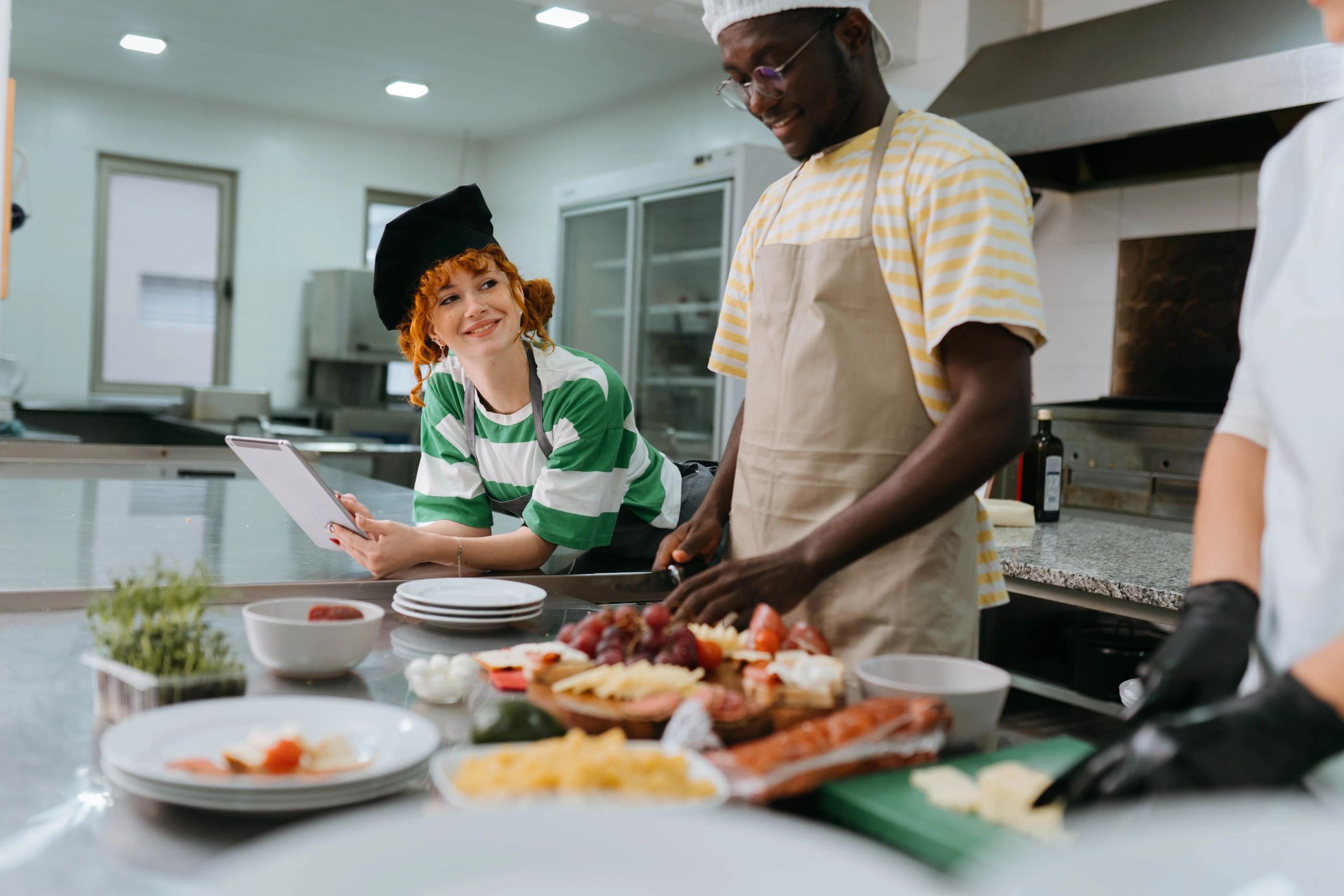 Students laughing with female chef during cooking class